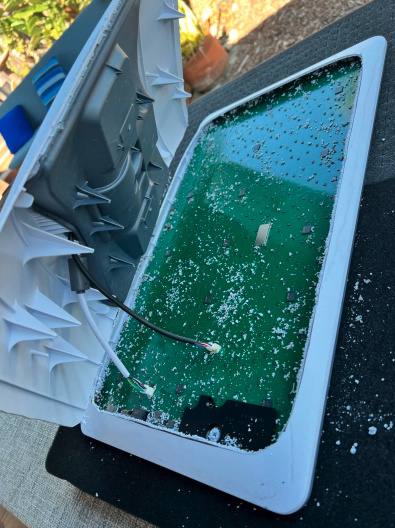 Dishy cutting for open installation (Alt text: Dishy being modified for installation)